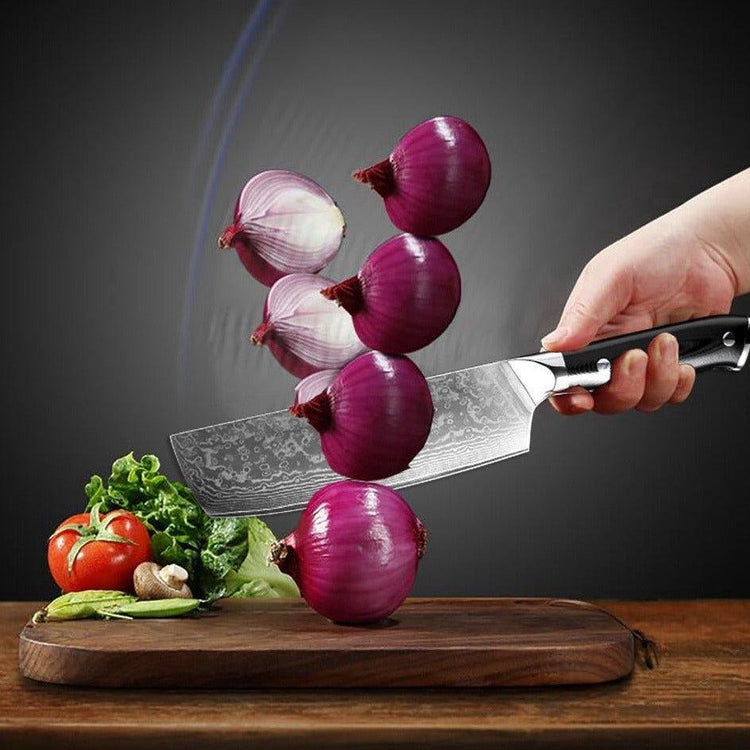 Stainless steel kitchen knife slicing red onions on wooden board with vegetables, Fansee Australia.