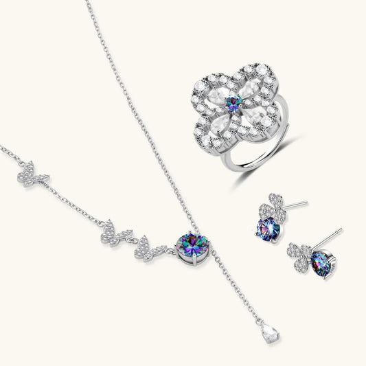 Elegant silver jewelry set with butterfly necklace, floral ring, and stud earrings featuring rainbow gemstones