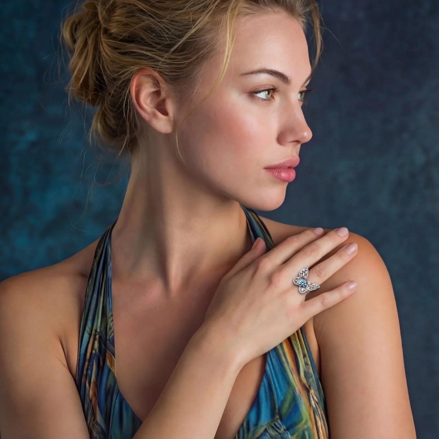 Elegant woman wearing a butterfly diamond ring, showcasing luxury jewelry against a deep blue backdrop.