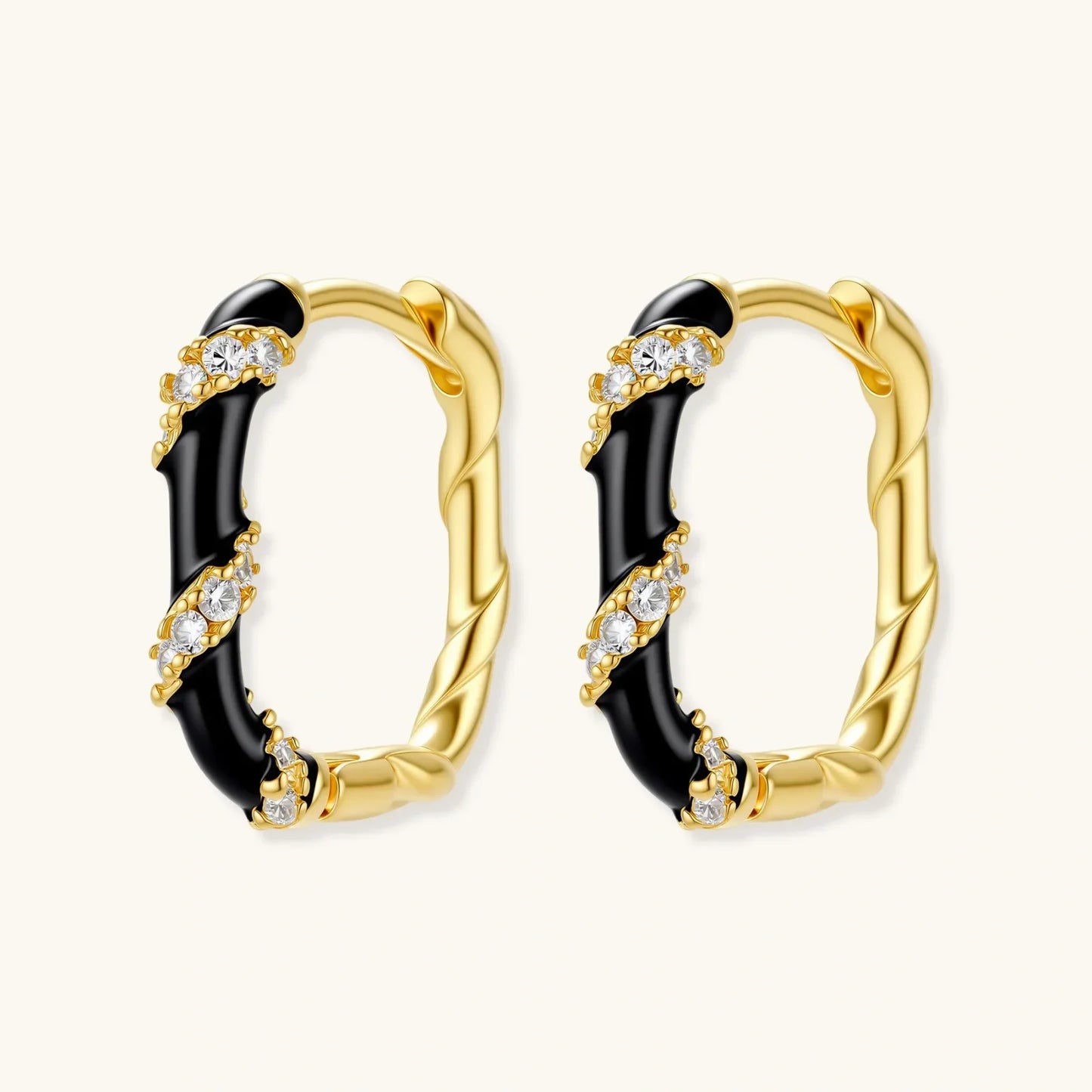 Gold hoop earrings with black enamel and crystal accents, elegant statement jewelry for women