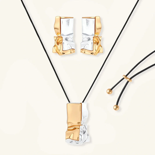 Modern gold and silver tone pendant necklace with matching earrings, abstract textured design