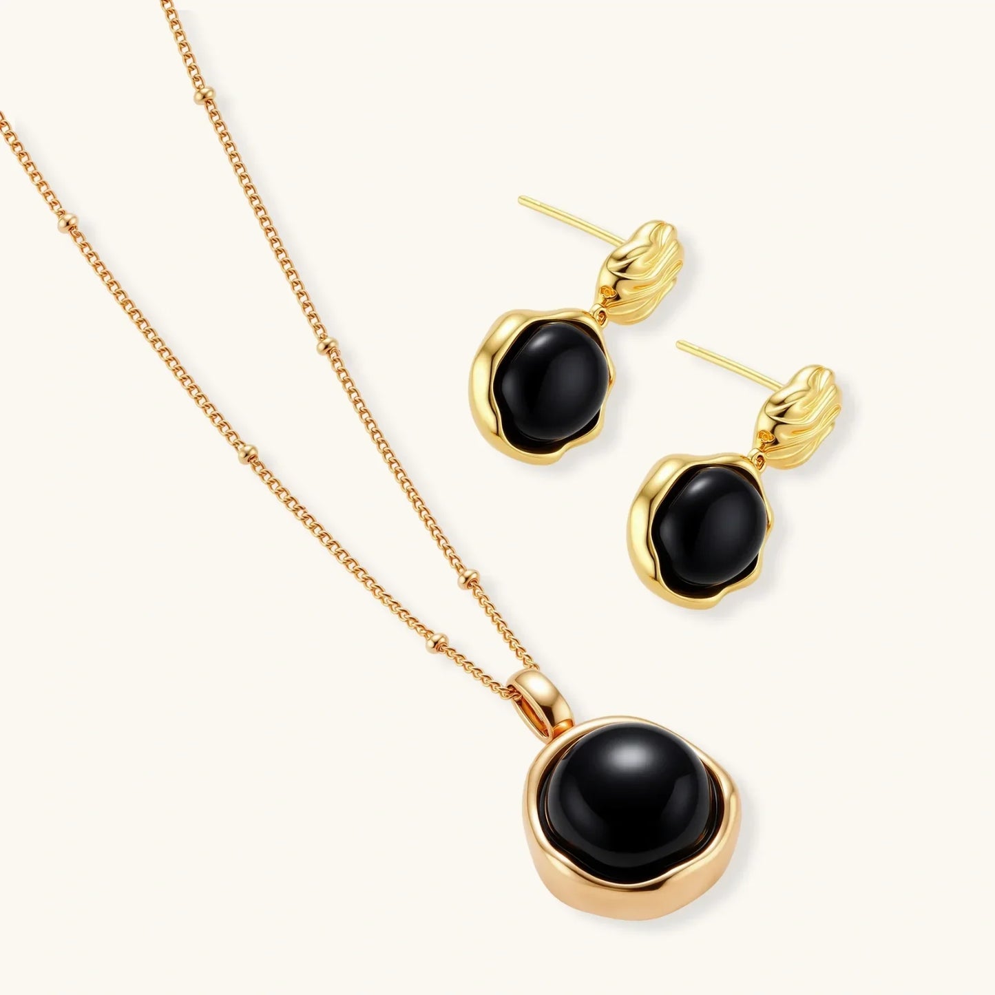 Elegant gold necklace and stud earrings with black onyx stones, luxury jewelry set for women
