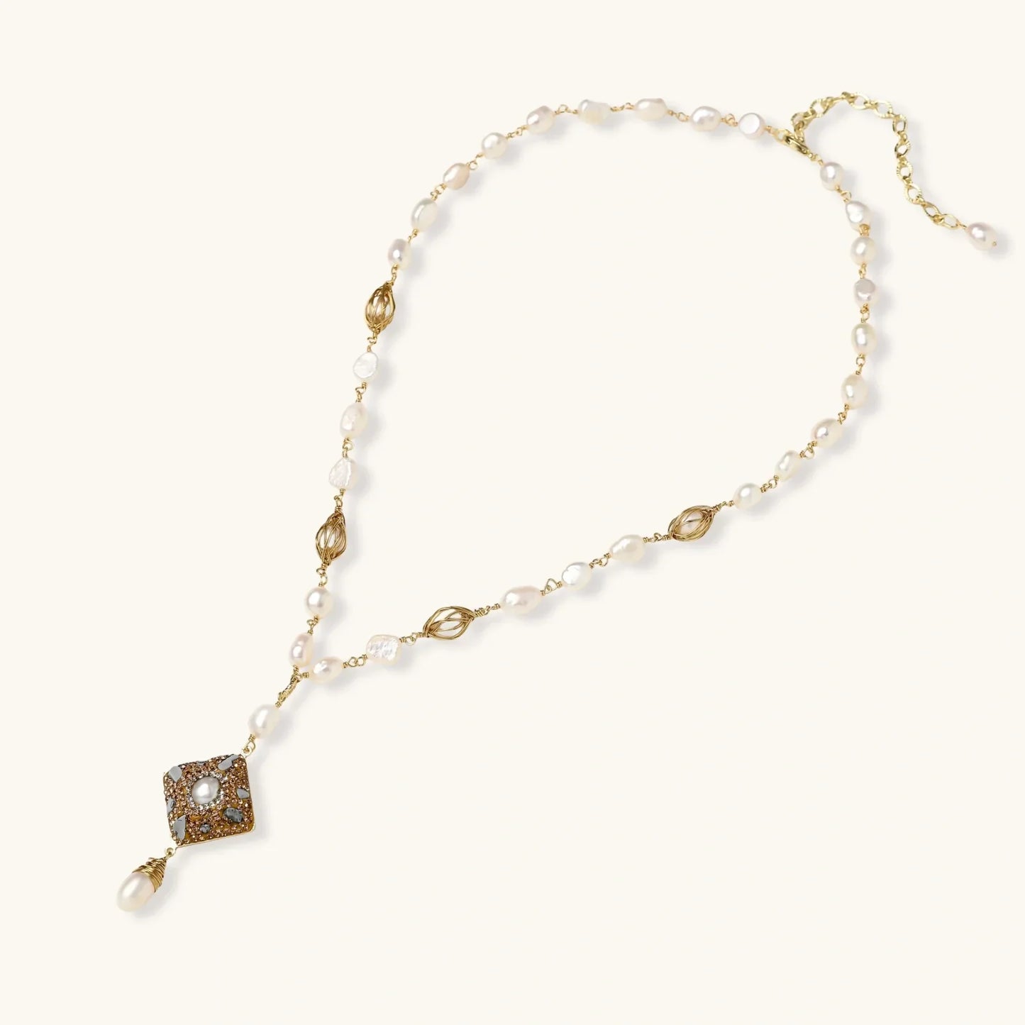 Elegant pearl necklace with gold chain and square pendant, perfect for home décor or gifting