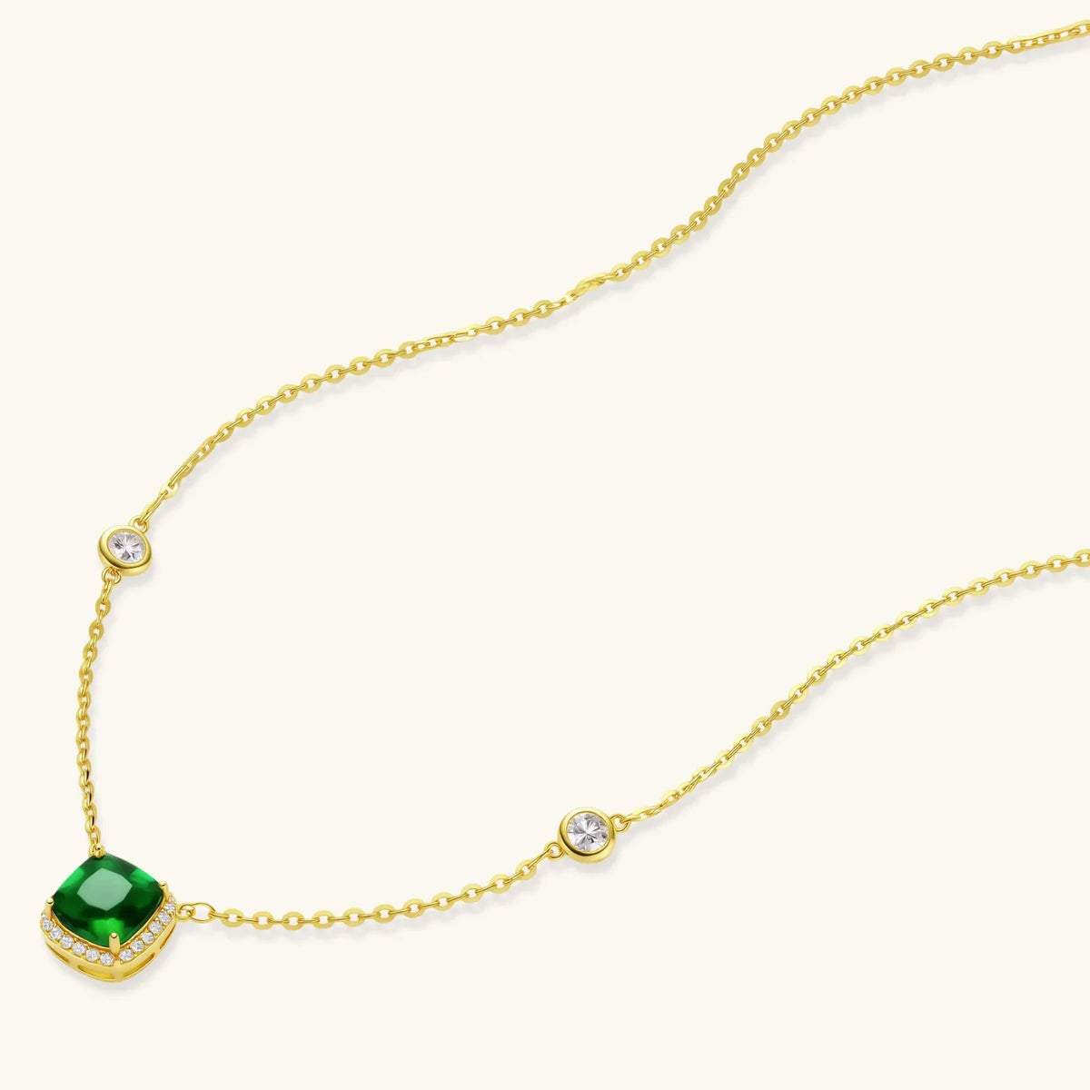 Elegant gold necklace with emerald pendant and diamond accents, perfect for luxury home gifting