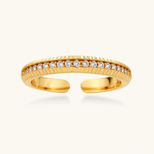 Gold open ring with textured band and row of clear crystals, elegant women's jewelry