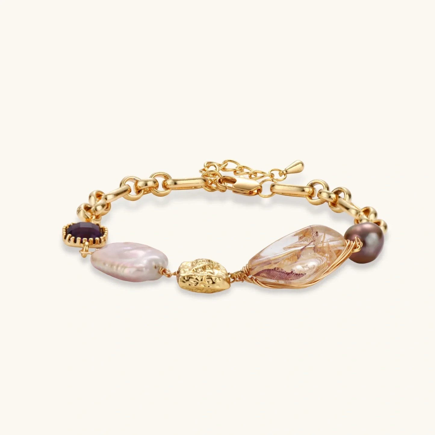 Gold chain bracelet with pearls, amethyst, and textured charms for elegant home décor gifting