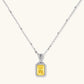Yellow moissanite jewelry set with emerald-cut stones in sterling silver halo settings on white background.