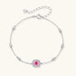 Sterling silver jewelry set featuring pink moissanite stones in halo settings on white background.
