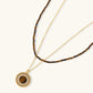 Gold tone layered necklace with tiger's eye beads and crystal-encrusted pendant, elegant women's jewelry
