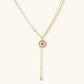 Elegant gold lariat necklace with pink gemstone pendant and diamond accents, perfect for stylish home gifting.