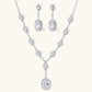 Elegant white gold plated jewelry set with oval cubic zirconia stones in halo settings, featuring Y-necklace and drop earrings.