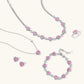 Pink heart crystal jewelry set with necklace, bracelet, earrings, and ring for elegant gifting
