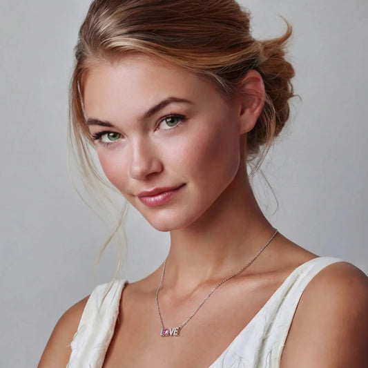 Woman wearing delicate 'LOVE' pendant necklace with pink gemstone, ideal for gifting or everyday elegance.