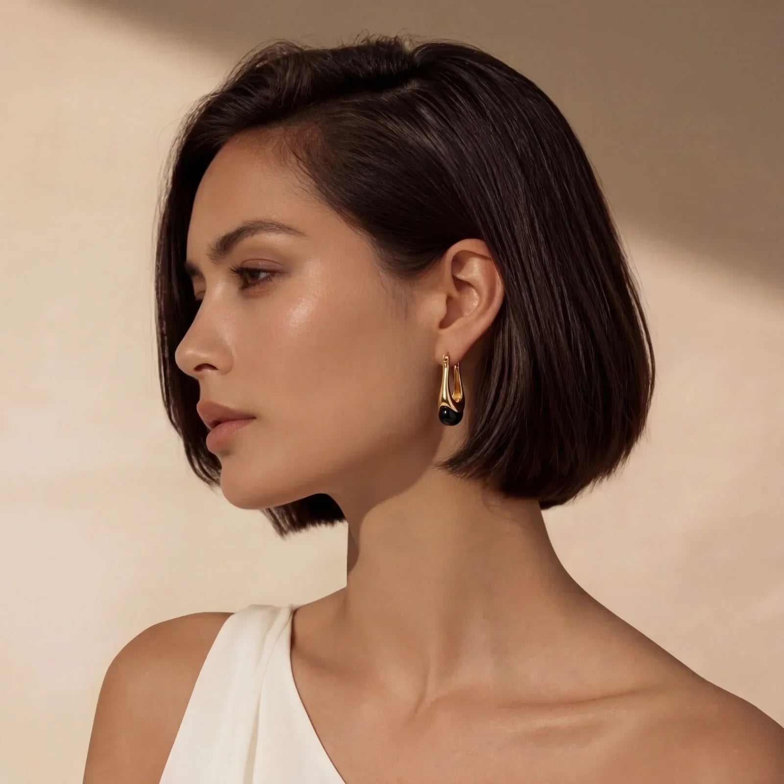 Elegant gold hoop earrings with black accent, styled for modern home décor and gifting