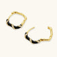 Gold hoop earrings with black enamel and crystal accents, elegant statement jewelry for women