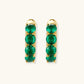 Gold hoop earrings with four emerald green gemstones, elegant statement jewelry for women