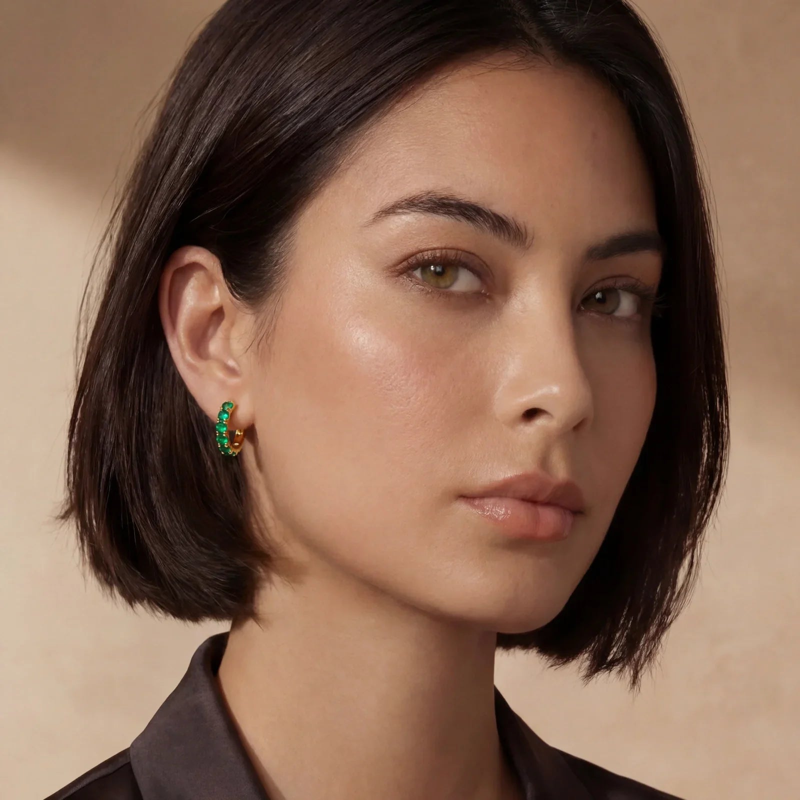 Woman wearing green gemstone hoop earrings, stylish home decor accessory