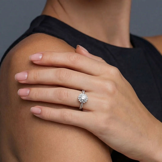 Elegant diamond halo engagement ring on woman's hand, sparkling with brilliance