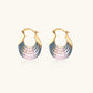 Gold hoop earrings with gradient blue-to-pink enamel in ribbed fan design on beige background
