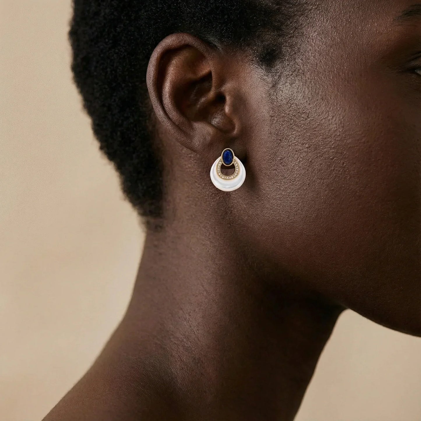Elegant white and blue gemstone earring with gold accents, styled for modern home décor lovers.