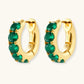Gold hoop earrings with emerald green gemstones, elegant statement jewelry for women