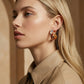 Stylish gold and silver hoop earrings on blonde woman, modern fashion accessory