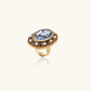 Elegant gold ring with floral cameo and pearl accents, vintage-inspired statement jewelry