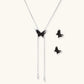 Dark wood butterfly earrings and necklace with silver chain accents on white background, showing natural grain texture.