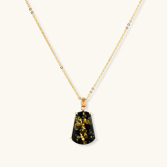 Elegant gold chain necklace with black pendant featuring golden leaf accents, perfect for stylish home décor gifting.
