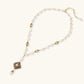 Y-shaped necklace with freshwater pearls, gold filigree stations, and ornate diamond-shaped centerpiece with pearl drop