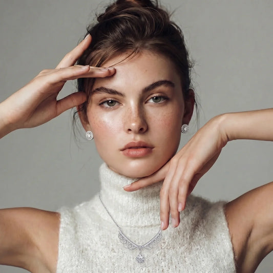 Elegant woman wearing sparkling diamond necklace and stud earrings, styled with white turtleneck for luxury home décor gifting
