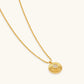 Gold sunburst pendant necklace with crystal center on twisted chain, elegant everyday jewelry