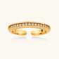 Gold open ring with textured band and row of clear crystals, elegant women's jewelry