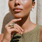 Woman wearing gold butterfly ring with pearl earrings, styled for elegant home décor gifting