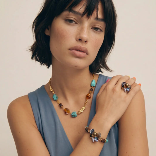 Woman wearing boho turquoise and amber stone necklace, bracelet, and ring set for stylish home décor gifting