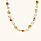 Elegant gold necklace with amber teardrop beads and white pearls, perfect for stylish home décor or gifting.