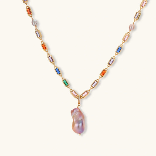 Elegant gold necklace with colorful gemstones and a large baroque pearl pendant, perfect for luxury home décor gifting.