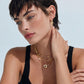 Woman wearing layered gold necklaces and diamond-shaped earrings, stylish home décor accessory