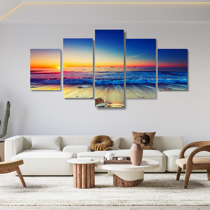 Five-panel wall art of a beach sunset in a living room setting.