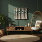 Modern living room with artisan home decor, green wall, wooden furniture, and hanging chair.