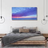 Modern bedroom with wooden bed, grey bedding, pendant lights, and ocean sunset wall art from Fansee Australia.