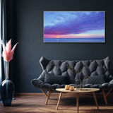 Modern Australian home decor with dark sofa, coastal wall art, and elegant coffee table setup