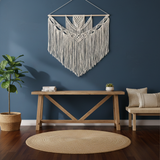 Modern artisan home decor with macrame wall hanging, wooden bench, and woven rug from Fansee Australia.