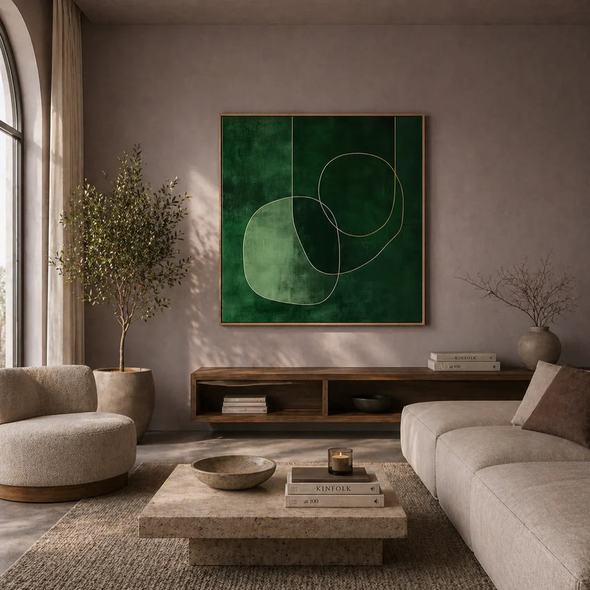 Modern living room with a green abstract painting on the wall, beige sofa, and round coffee table.