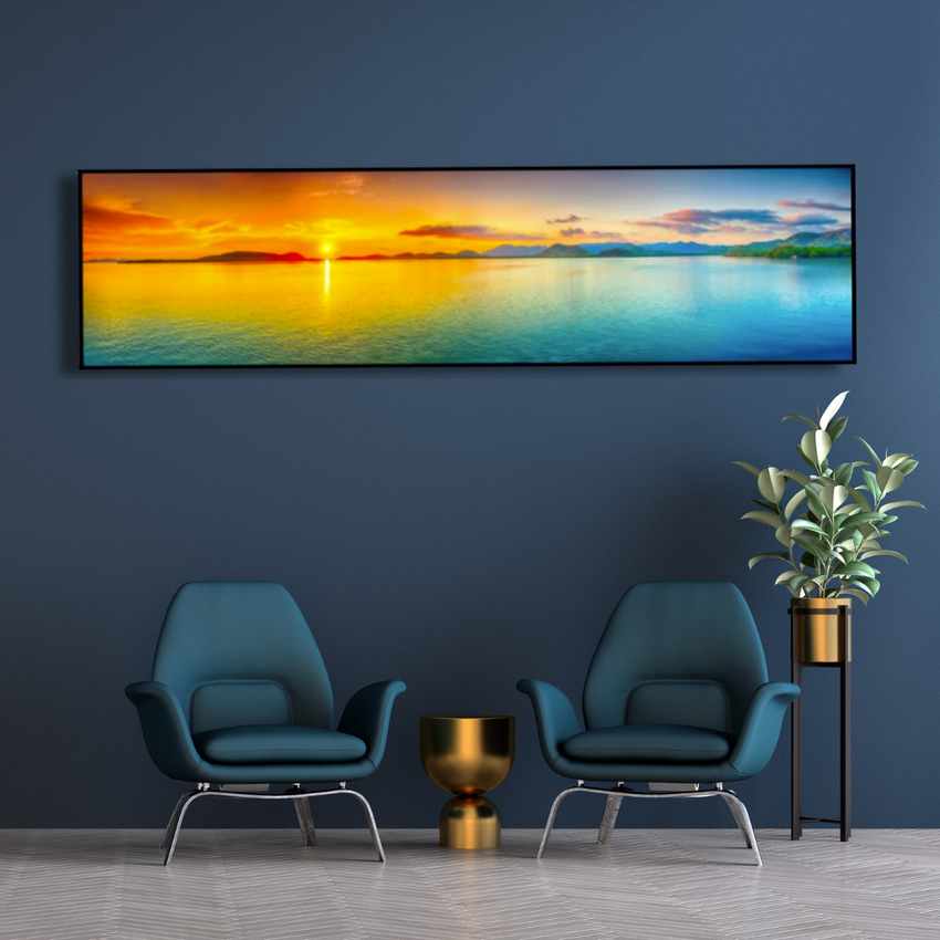 Modern lounge with blue chairs, gold decor, and vibrant sunset wall art, Fansee Australia style
