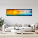 Modern living room with white sofas, minimalist decor, and panoramic ocean sunset wall art