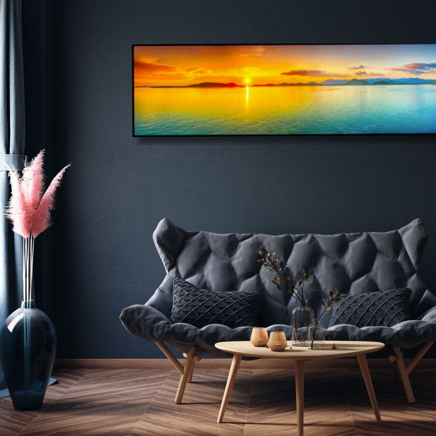 Modern living room with dark sofa, wooden table, pampas grass decor, and ocean sunset wall art