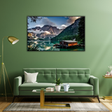 Modern living room with green sofa, wall art of mountain lake landscape, stylish home decor