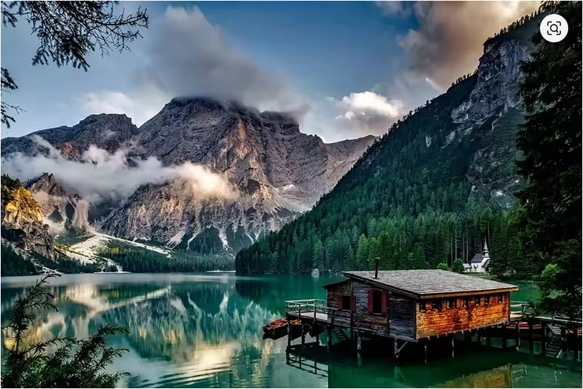 Scandinavian landscape canvas art featuring mountains, lake, and rustic cabin wall decor