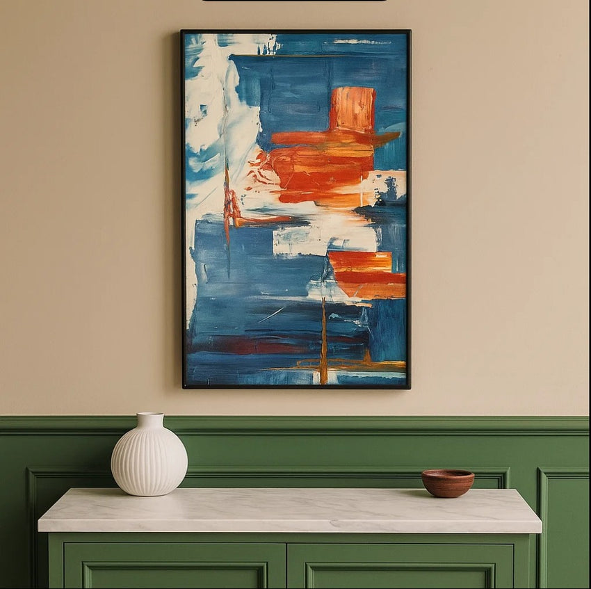 Abstract orange and blue wall art above green console with white vase and wooden bowl